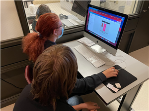 3 students work on computer ad